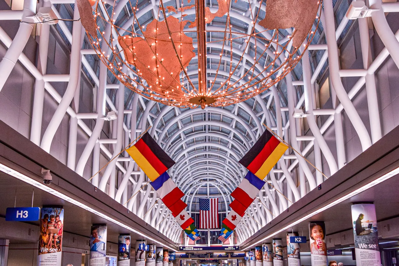 Travelers walking beneath the arched ceiling in Chicago O'Hare airport