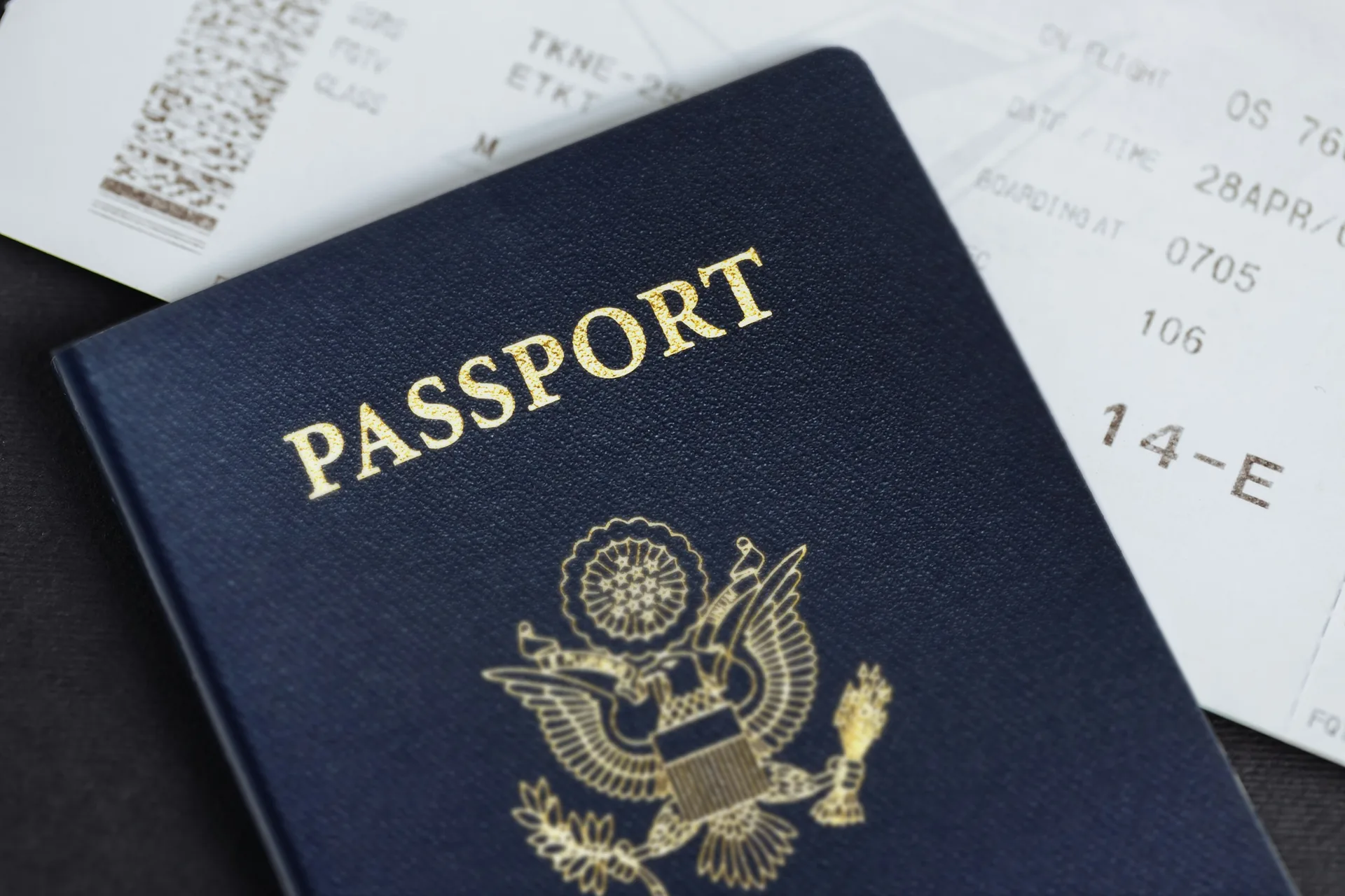 U.S. passport resting on an airline boarding pass