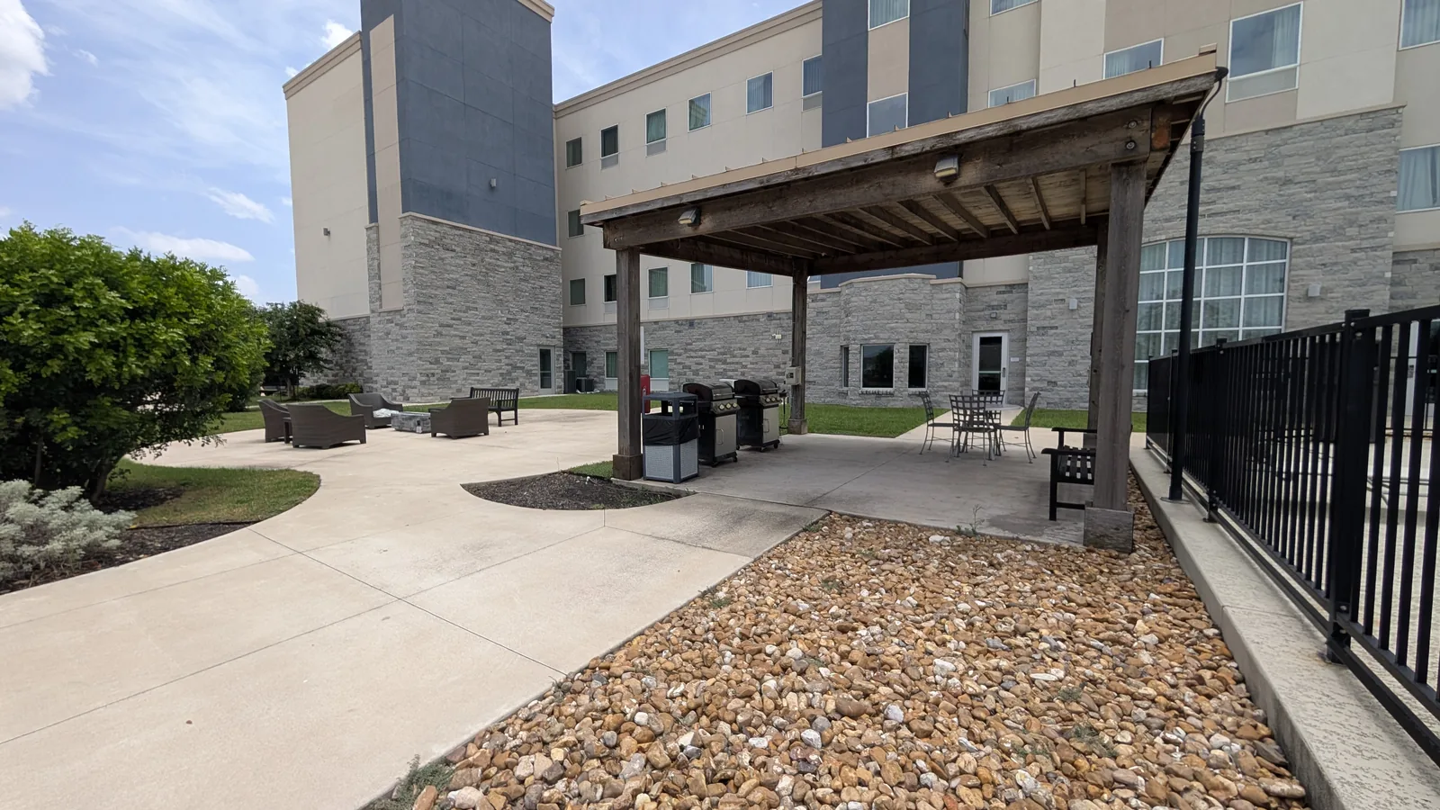 Outdoor grills and seating behind the hotel beside the pool area